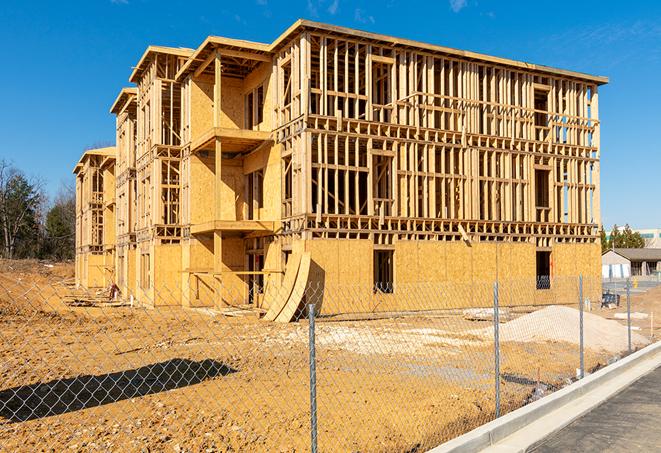 a snapshot of temporary chain link fences protecting a large construction project from unauthorized access in Wellesley Hills